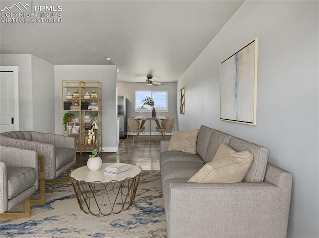 living room featuring hardwood / wood-style floors and ceiling fan