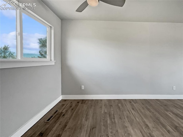 spare room with ceiling fan and dark hardwood / wood-style flooring