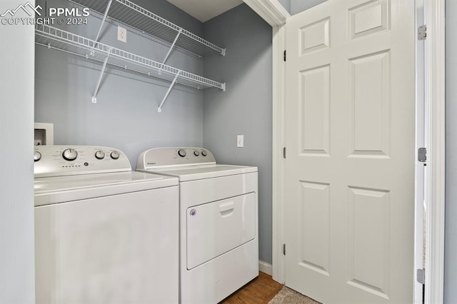 washroom featuring separate washer and dryer and hardwood / wood-style flooring