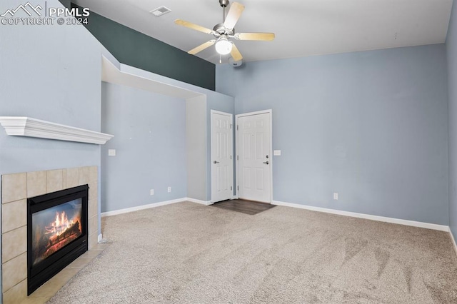 unfurnished living room with ceiling fan, light carpet, and a tile fireplace