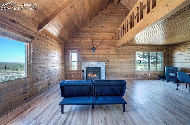 living room featuring a healthy amount of sunlight, wood-type flooring, and wood ceiling