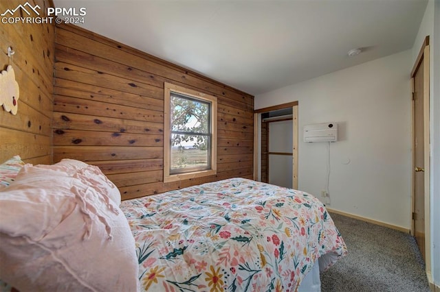 bedroom featuring a wall mounted air conditioner, carpet, wooden walls, and a closet