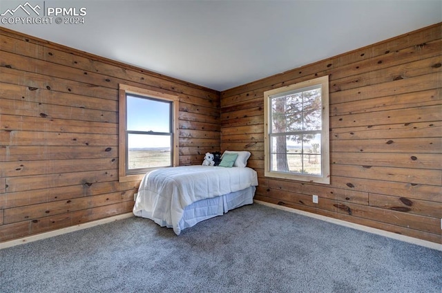 carpeted bedroom with wooden walls