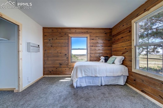 carpeted bedroom featuring a wall mounted AC and wood walls