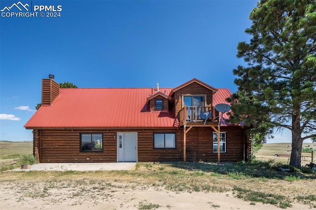 log home featuring a balcony