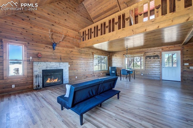 playroom with wood walls, high vaulted ceiling, wooden ceiling, and wood-type flooring