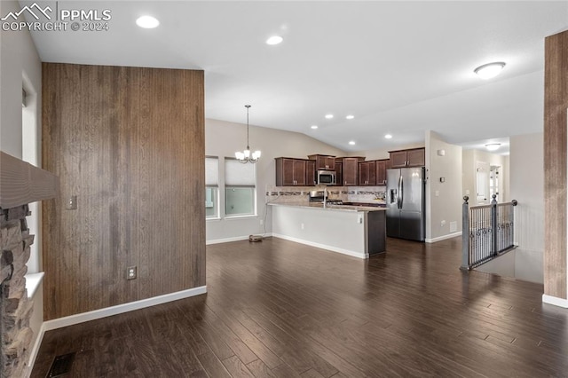 interior space featuring vaulted ceiling, sink, a notable chandelier, and dark hardwood / wood-style flooring