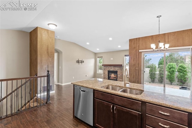 kitchen featuring light stone counters, stainless steel appliances, sink, lofted ceiling, and kitchen peninsula