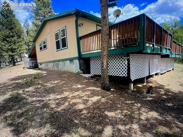 back of property with a wooden deck