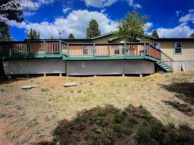 rear view of property featuring a deck