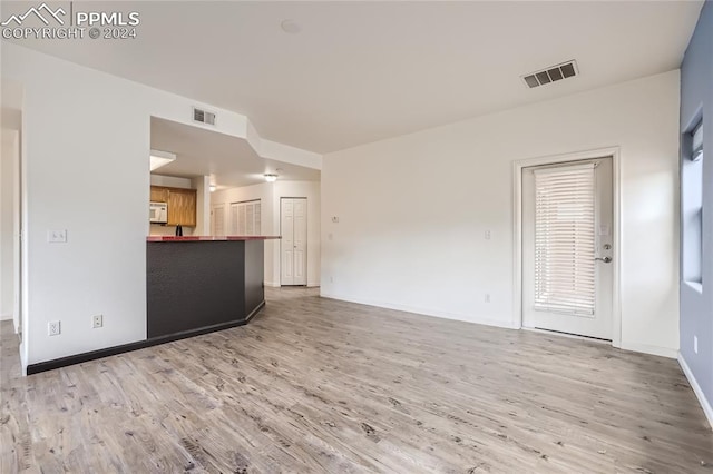 unfurnished living room with hardwood / wood-style flooring