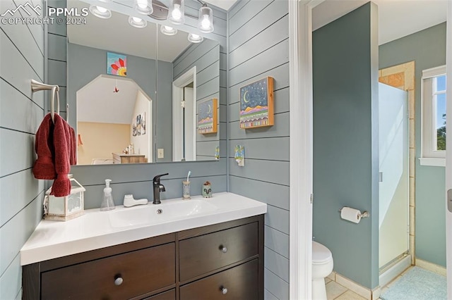 bathroom with vanity, a shower with door, tile patterned flooring, and toilet