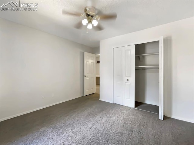 unfurnished bedroom featuring dark colored carpet, ceiling fan, and a closet