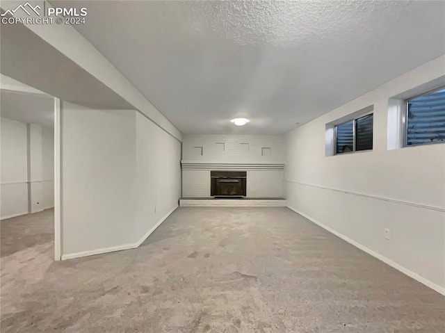 basement featuring carpet and a textured ceiling