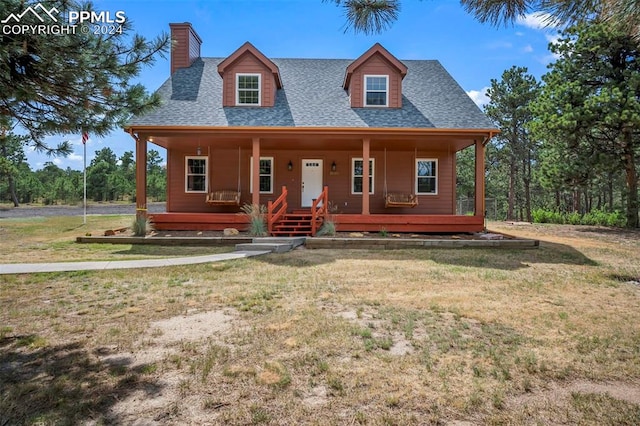 view of front of home with a front yard and covered porch