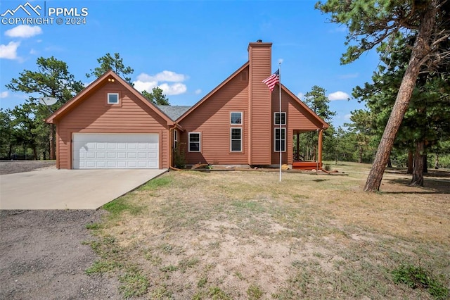 view of front of property with a garage and a front lawn