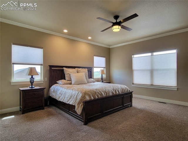 carpeted bedroom with crown molding and ceiling fan