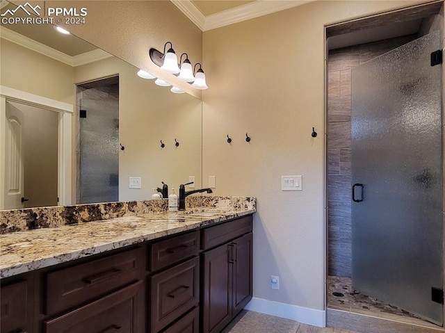 bathroom with vanity, tile patterned floors, a shower with shower door, and ornamental molding