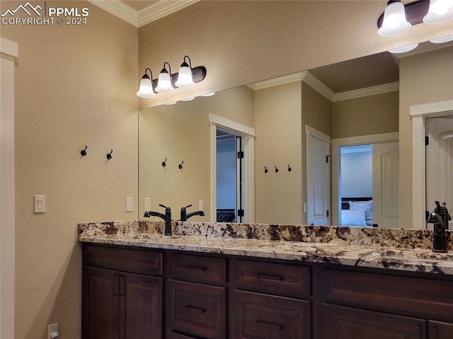 bathroom with ornamental molding and vanity