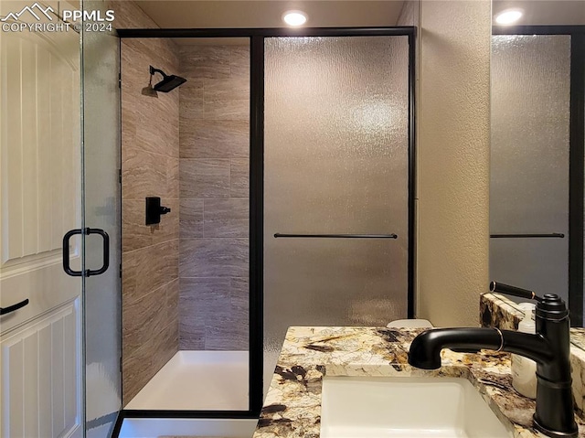 bathroom with vanity and an enclosed shower