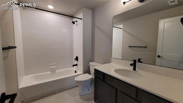 full bathroom with tile patterned floors, toilet, vanity, and washtub / shower combination