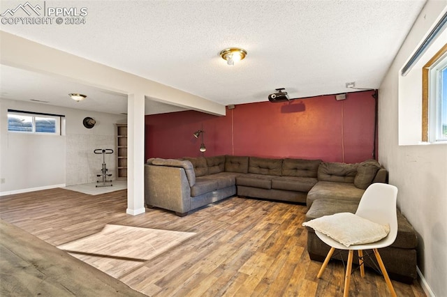 living room featuring hardwood / wood-style flooring and a textured ceiling