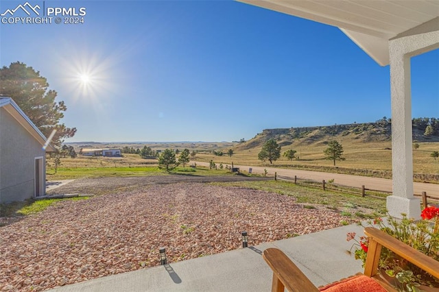 view of yard featuring a rural view and a patio area