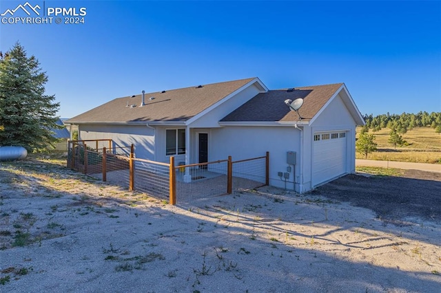 view of side of home featuring a garage