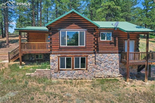 back of house with a wooden deck