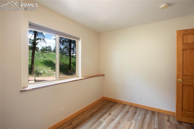 spare room with light hardwood / wood-style flooring