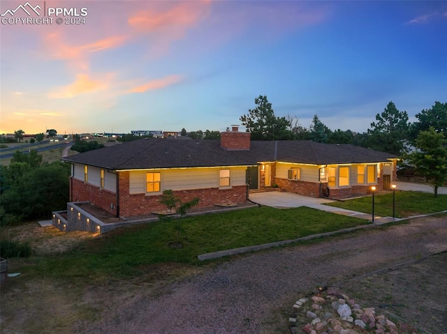 ranch-style house with a lawn