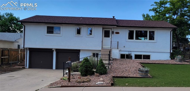 view of front of home with a front lawn and a garage