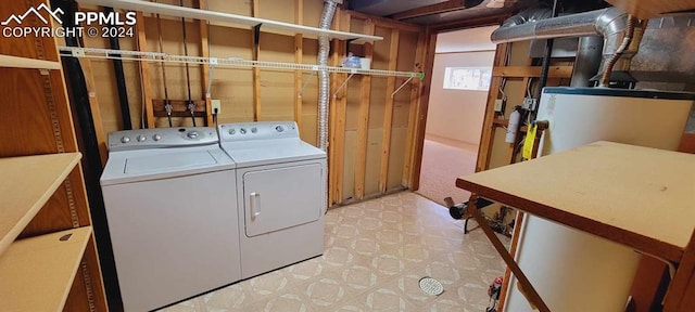 clothes washing area with separate washer and dryer and light colored carpet