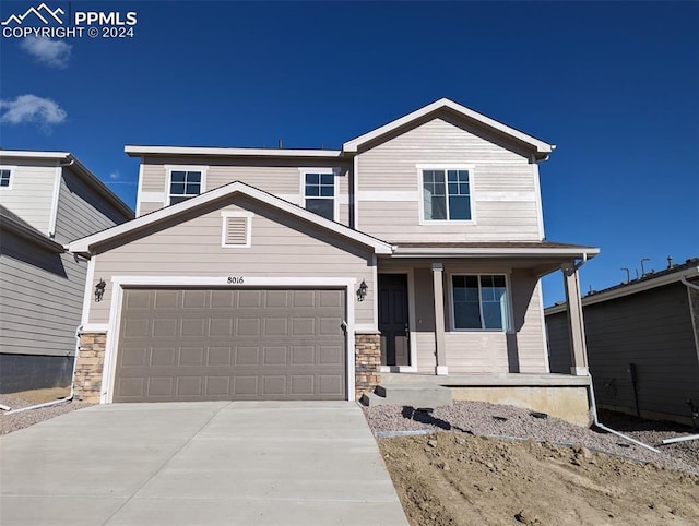 craftsman-style home with covered porch and a garage