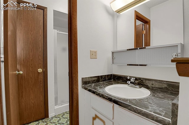 bathroom featuring vanity and a shower with shower door