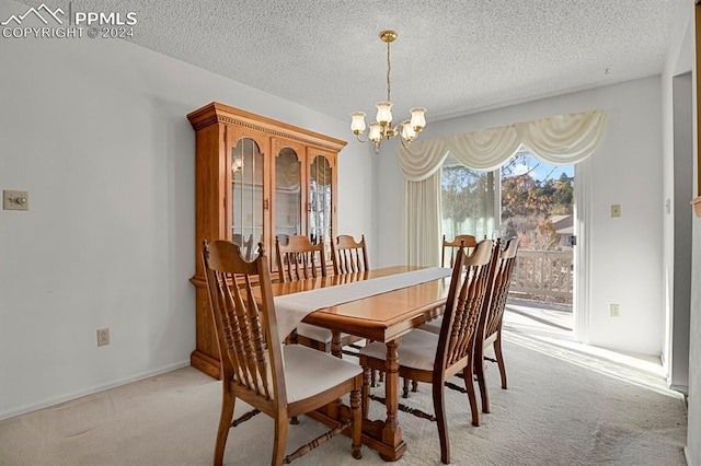 carpeted dining room with a chandelier and a textured ceiling