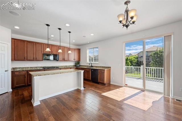 kitchen with sink, a center island, hanging light fixtures, and black appliances