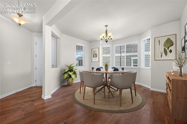 dining area featuring dark hardwood / wood-style floors and a chandelier