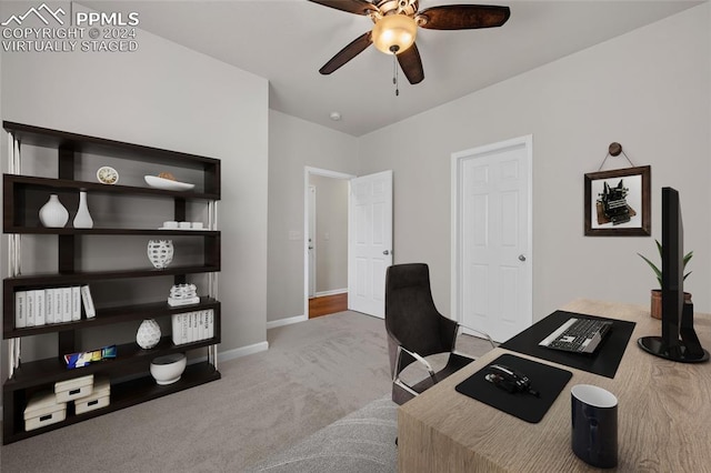 carpeted office featuring ceiling fan