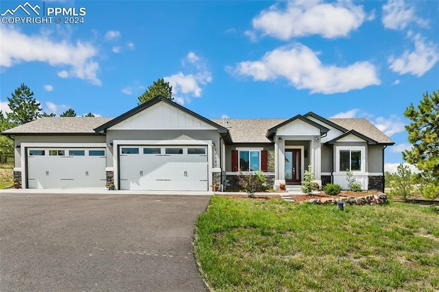 craftsman-style house with a garage and a front lawn