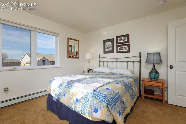 bedroom with a baseboard radiator and carpet flooring