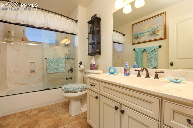 full bathroom featuring tile patterned flooring, bath / shower combo with glass door, vanity, and toilet