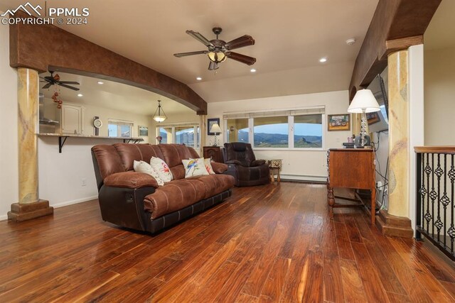 living room with dark hardwood / wood-style flooring, a baseboard heating unit, vaulted ceiling, and ceiling fan