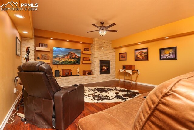 living room with ceiling fan, dark hardwood / wood-style floors, and a fireplace