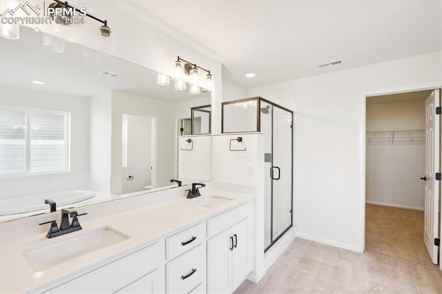 bathroom with vanity and a shower with shower door