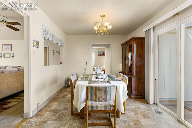 dining area featuring ceiling fan with notable chandelier