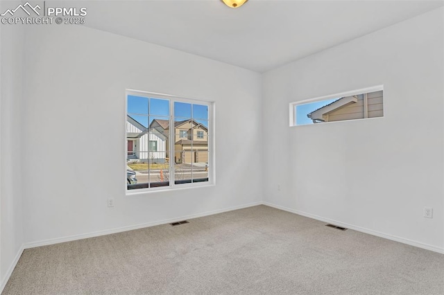carpeted empty room with baseboards