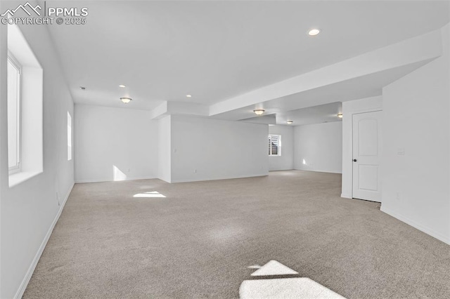 below grade area featuring carpet floors, baseboards, and recessed lighting