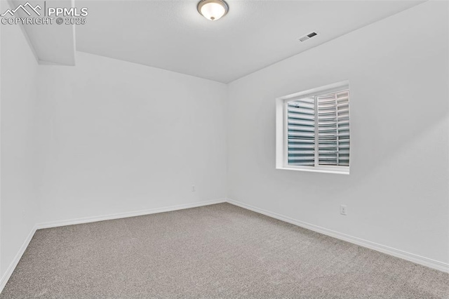 unfurnished room featuring carpet and baseboards