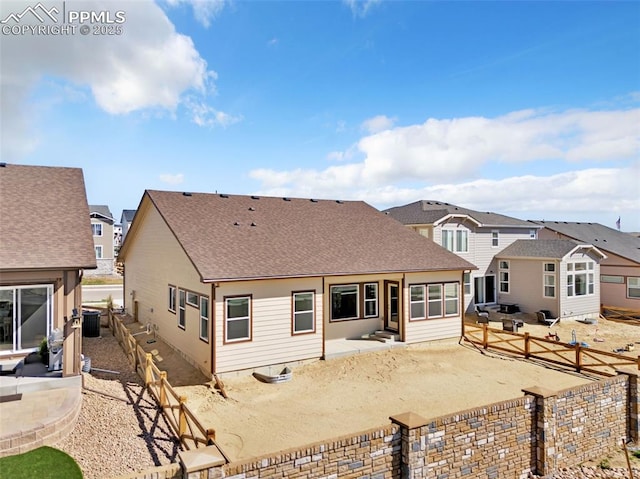 back of property featuring central air condition unit, a patio, a residential view, a fenced backyard, and a shingled roof